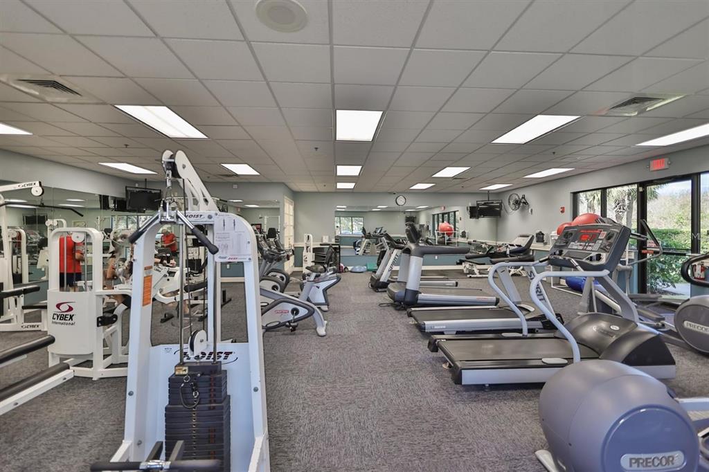 819 Fairwaycove Lane, Unit 102 Bradenton, FL 34212 - Photo 44 of 56 a view of a room with gym equipment