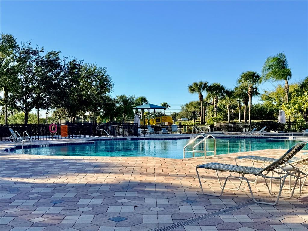 819 Fairwaycove Lane, Unit 102 Bradenton, FL 34212 - Photo 48 of 56 a view of swimming pool with seating area and trees in the background