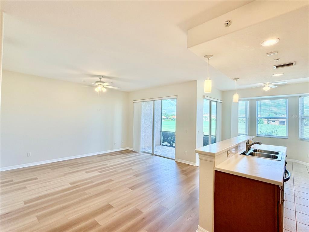 819 Fairwaycove Lane, Unit 102 Bradenton, FL 34212 - Photo 8 of 56 a view of workspace with wooden floor and windows