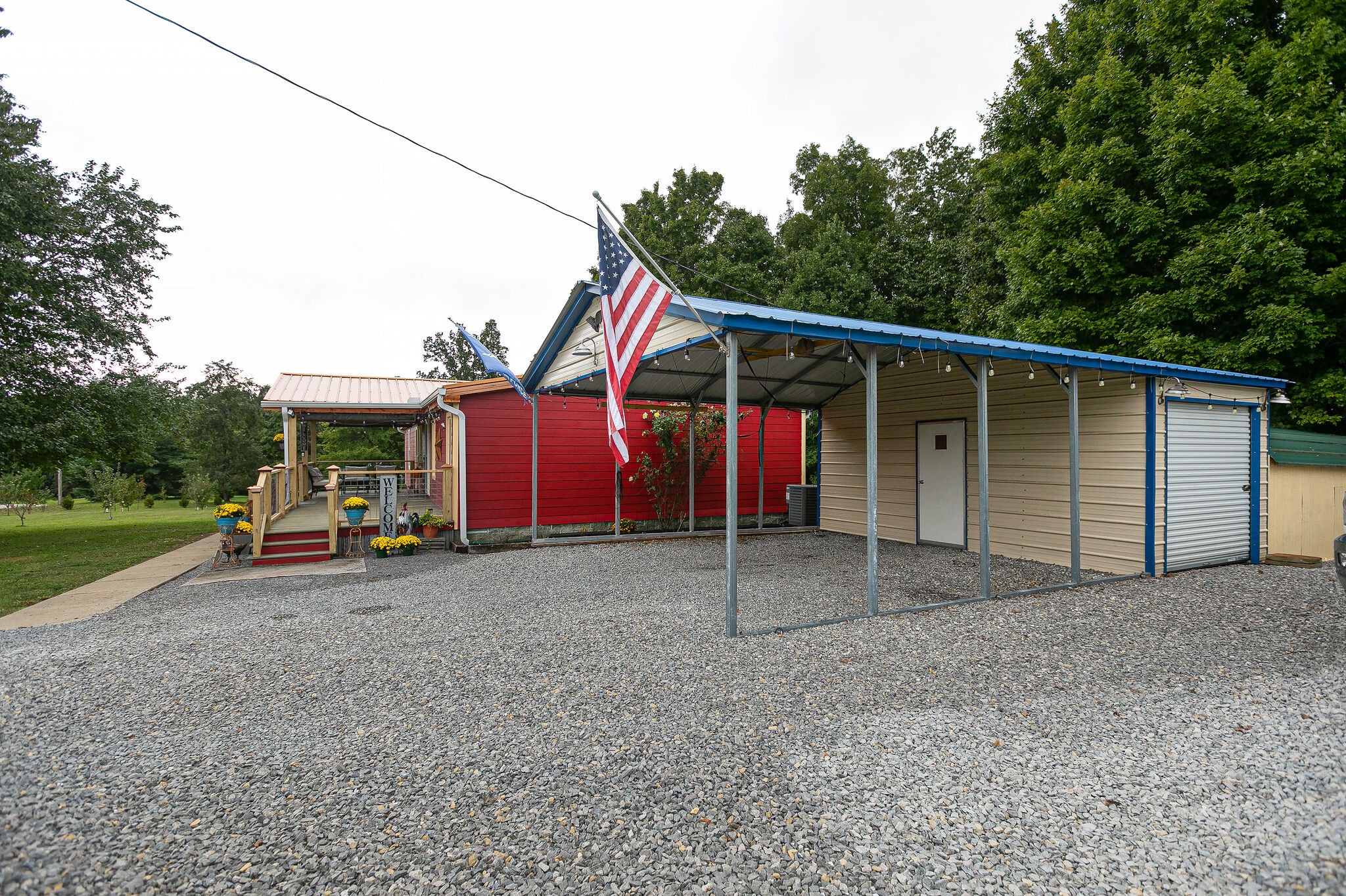 7791 Lampley Road Primm Springs, TN 38476 - Photo 6 of 32 a view of a house with a backyard and garage