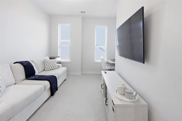 a bedroom with furniture and a flat screen tv