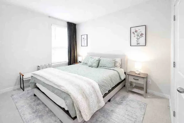 a bedroom with a bed and a window