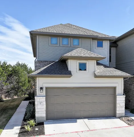a front view of a house with a garage