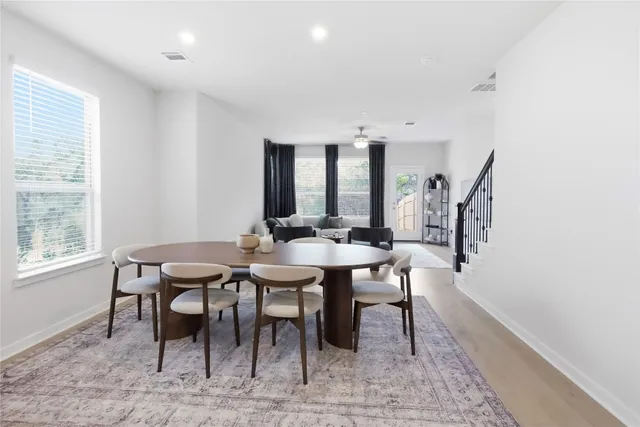 a view of a a dining room with furniture window and wooden floor