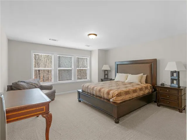 a bedroom with a bed couch and a window