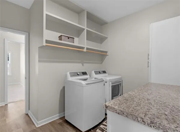a utility room with sink dryer and washer