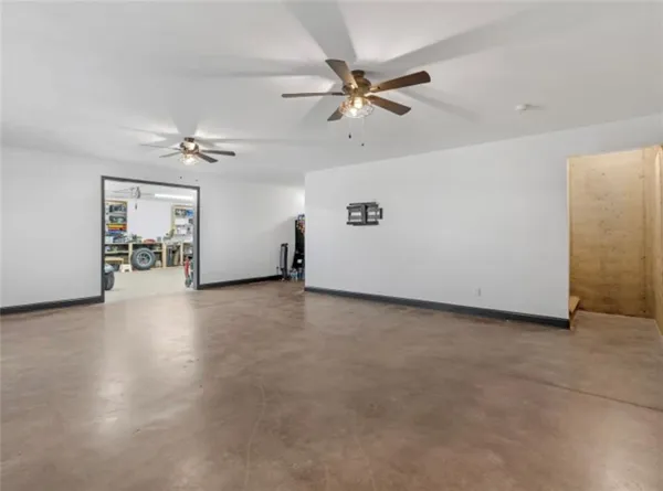 a view of a livingroom with a ceiling fan and hardwood floor