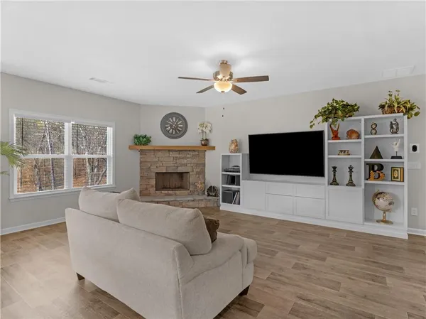 a living room with furniture a flat screen tv and a fireplace