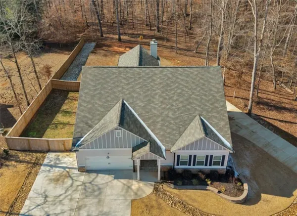 a house with tall trees in front of it