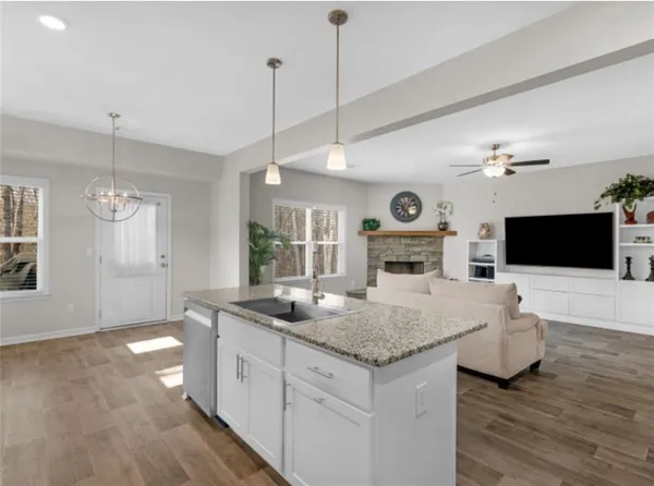 a hall with kitchen countertops and fireplace