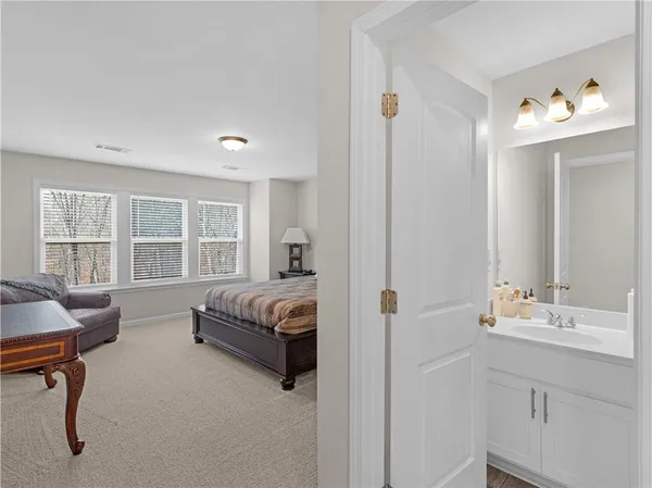 a spacious bedroom with a bed window and a couch