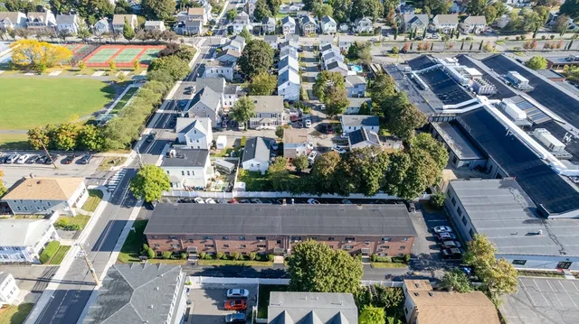 an aerial view of a city with lots of residential buildings ocean and mountain view