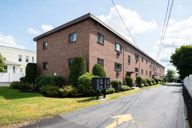 a front view of a house with yard and green space