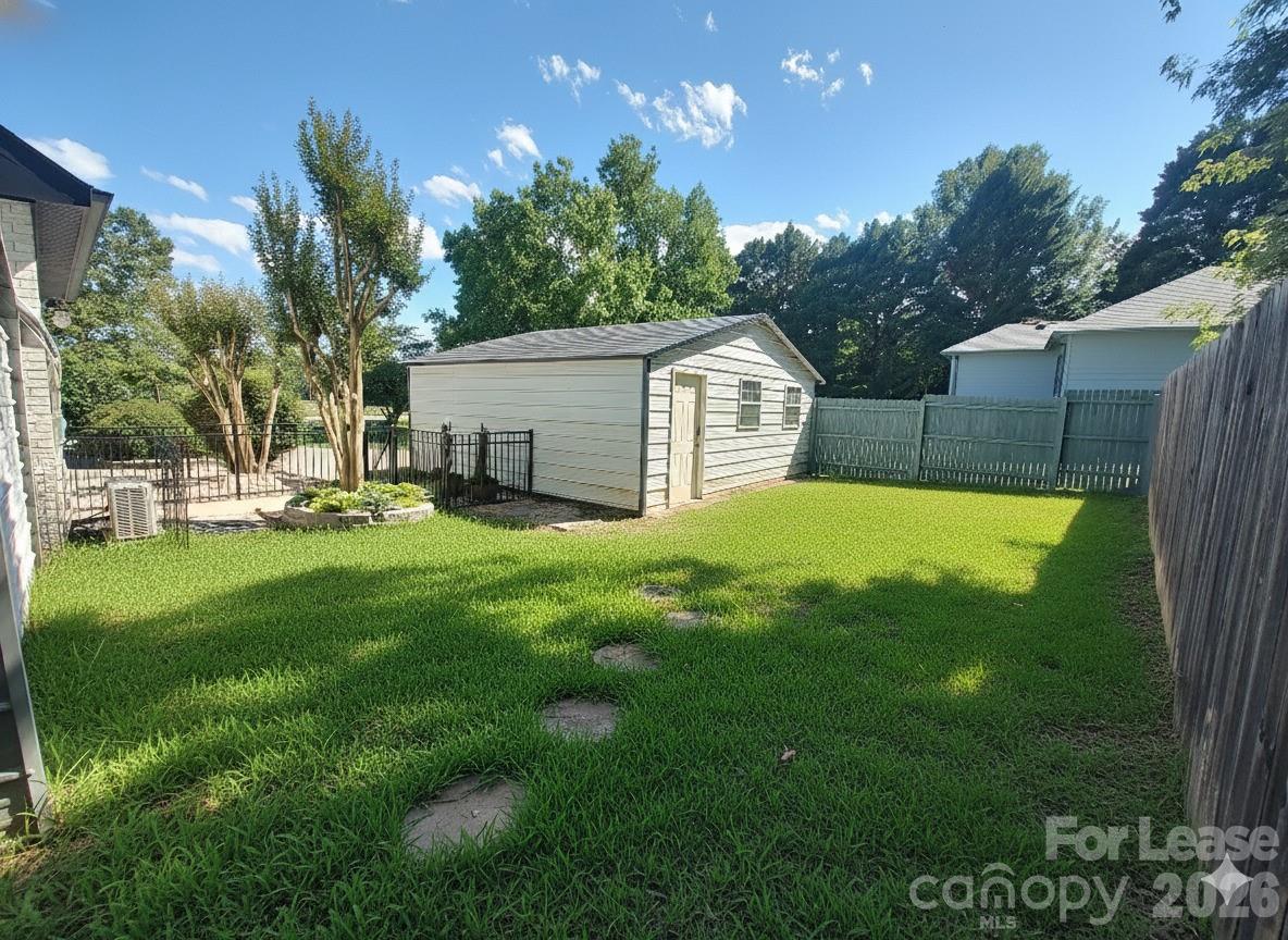 8478 Rocky River Road, Unit 1 Harrisburg, NC 28075 - Photo 7 of 8 a view of a house with a yard porch and sitting area