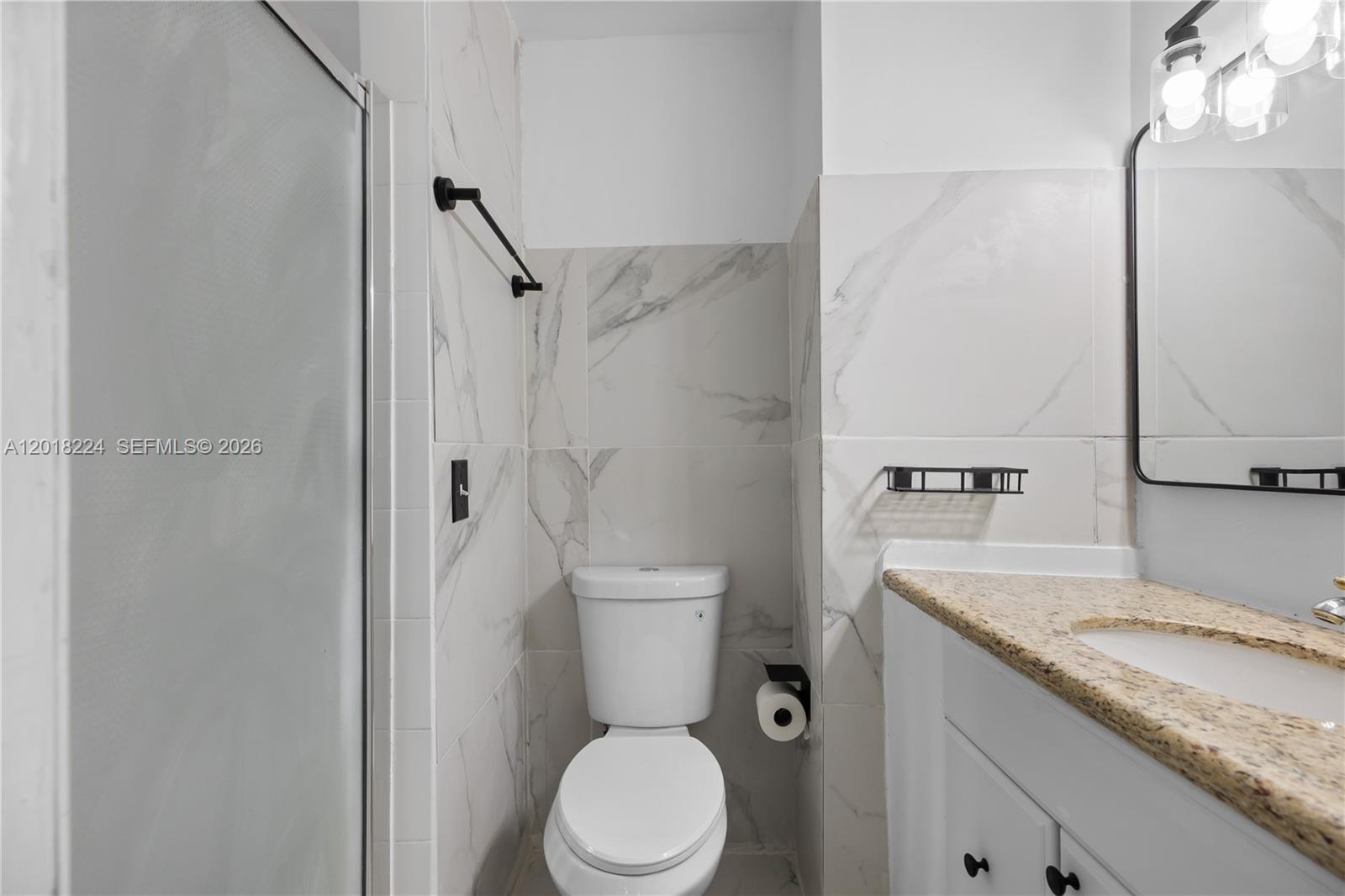 7958 Southwest 6th Street Pompano Beach, FL 33068 - Photo 38 of 57 a bathroom with a granite countertop sink toilet and shower