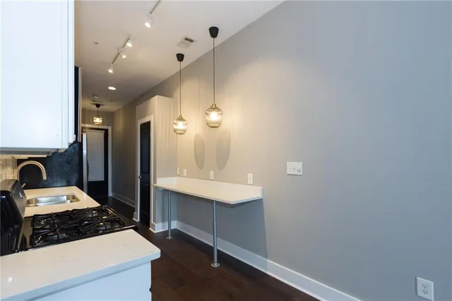 a kitchen with a sink appliances and cabinets