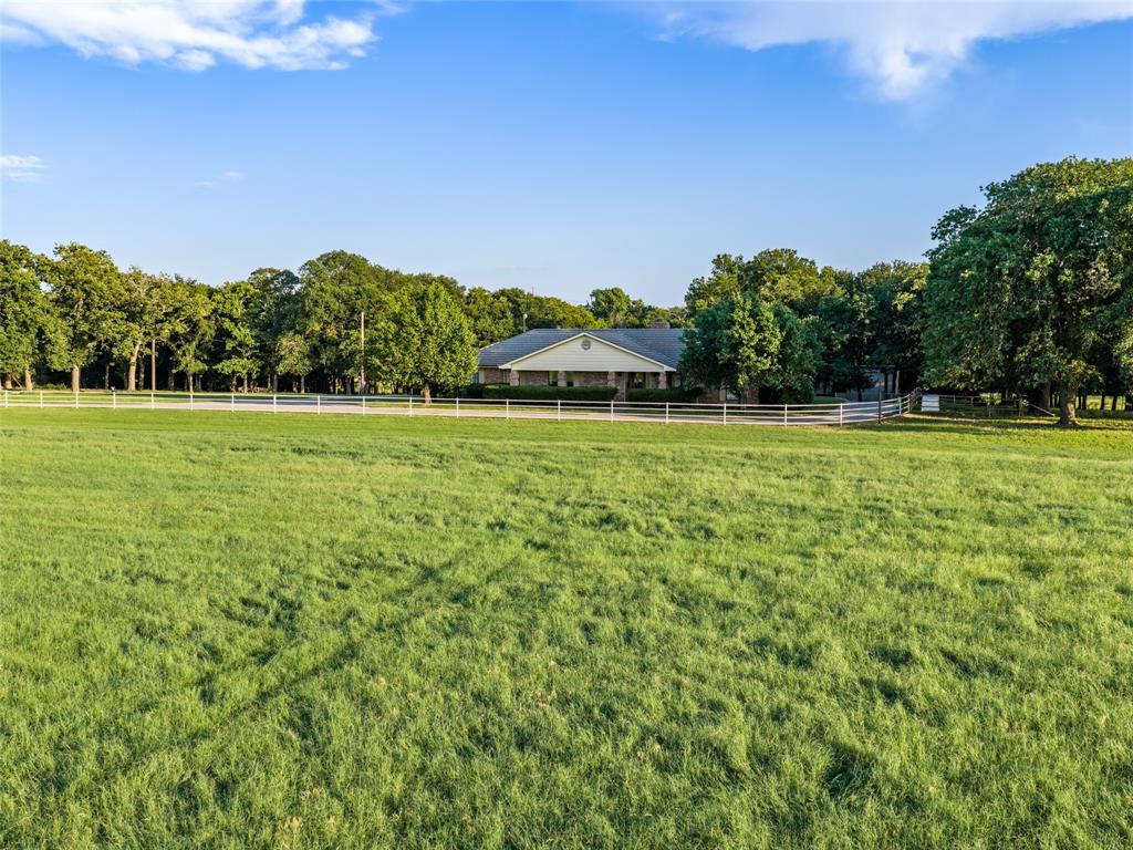 449 Private Road 4670 Rhome, TX 76078 - Photo 10 of 39 a backyard of a house with lots of green space and mountain view