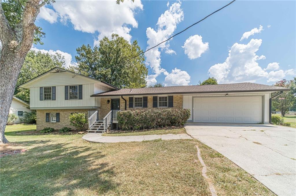 1864 North Road Snellville, GA 30078 - Photo 1 of 1 a front view of a house with a yard and garage