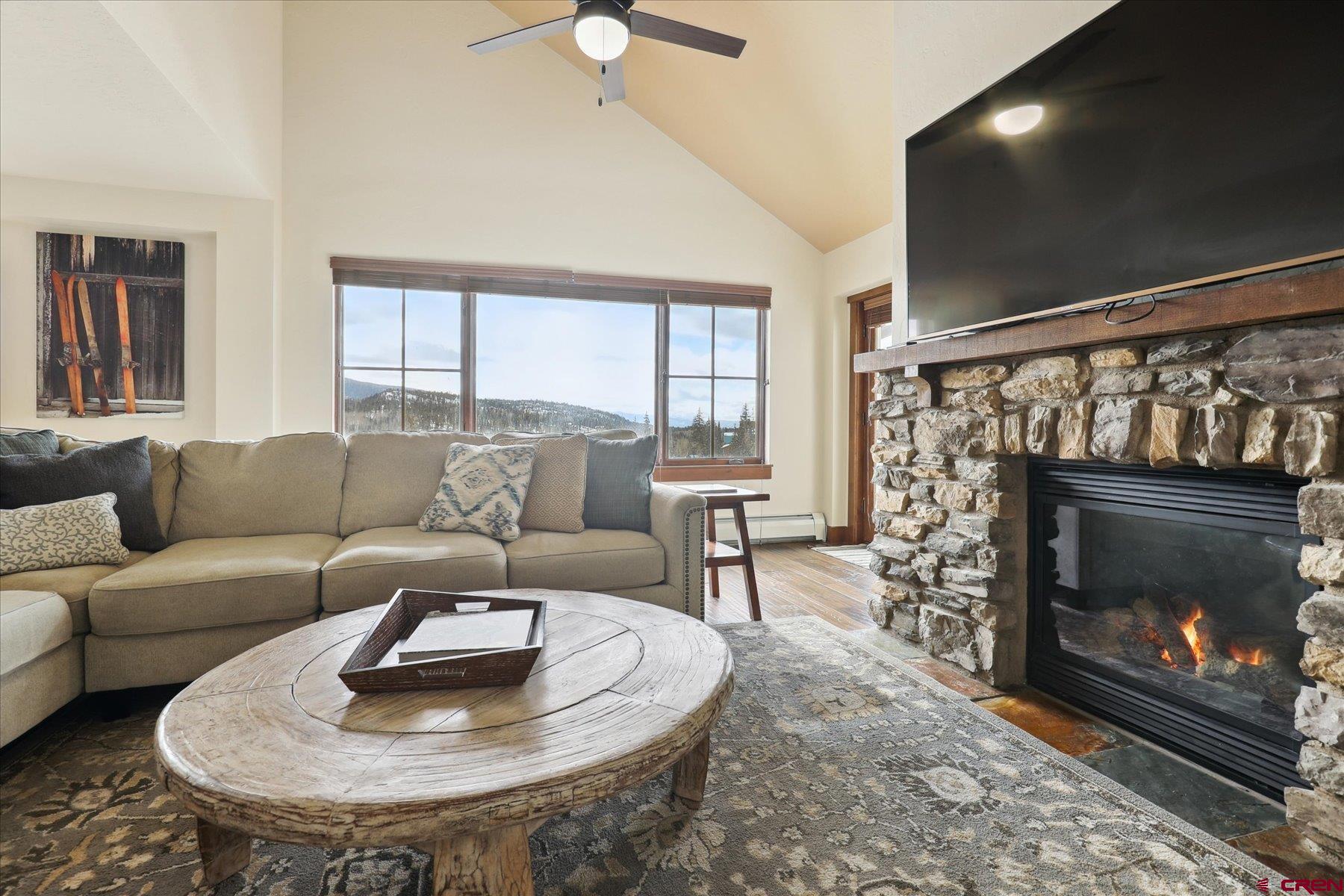 24 Sheol Street, Unit R505 Durango, CO 81301 - Photo 11 of 36 a living room with furniture a fireplace and a flat screen tv