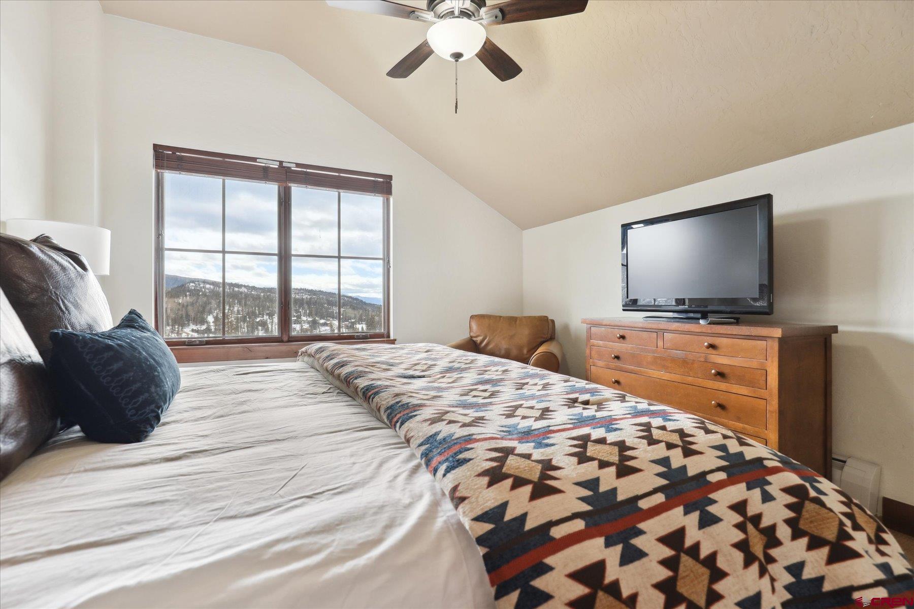 24 Sheol Street, Unit R505 Durango, CO 81301 - Photo 25 of 36 a bedroom with a bed television window and a flat screen tv