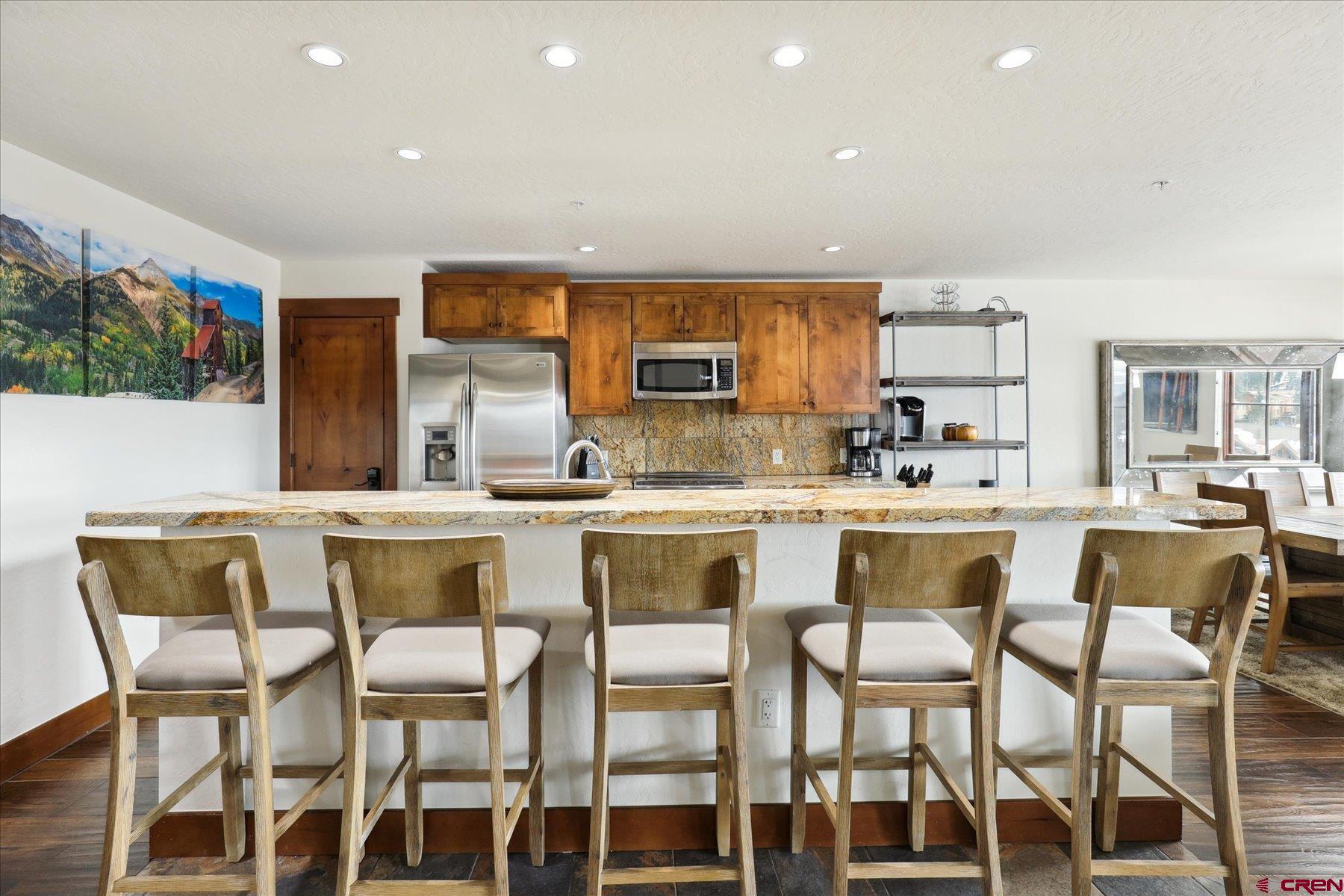 24 Sheol Street, Unit R505 Durango, CO 81301 - Photo 6 of 36 a dining room with stainless steel appliances kitchen island granite countertop a table and chairs