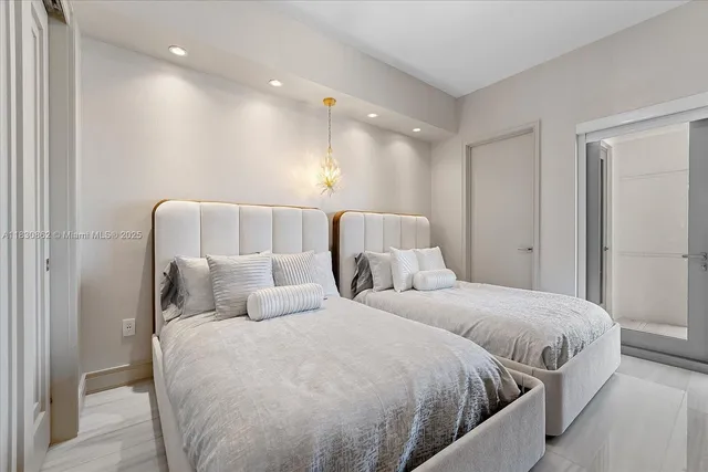 a bedroom with a bed and a night stand