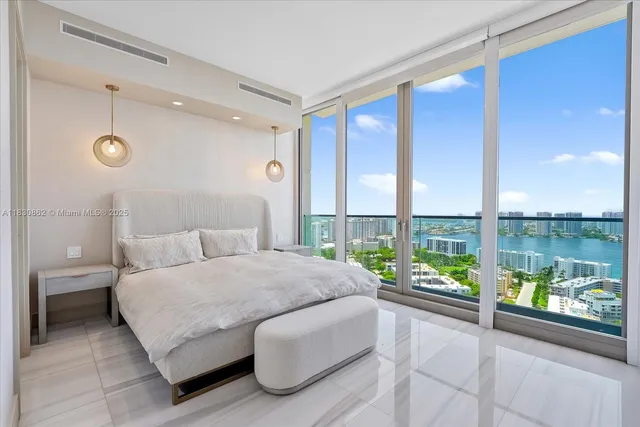 a spacious bedroom with a large bed and a large window