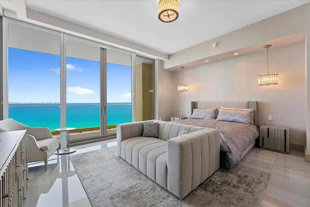 a bedroom with a bed and glass window