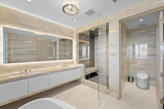 a spacious bathroom with a tub sink and mirror