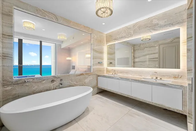 a large spacious bathroom with a large tub and sink