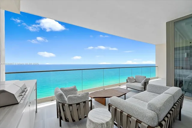 a view of a dining room with furniture and a large window