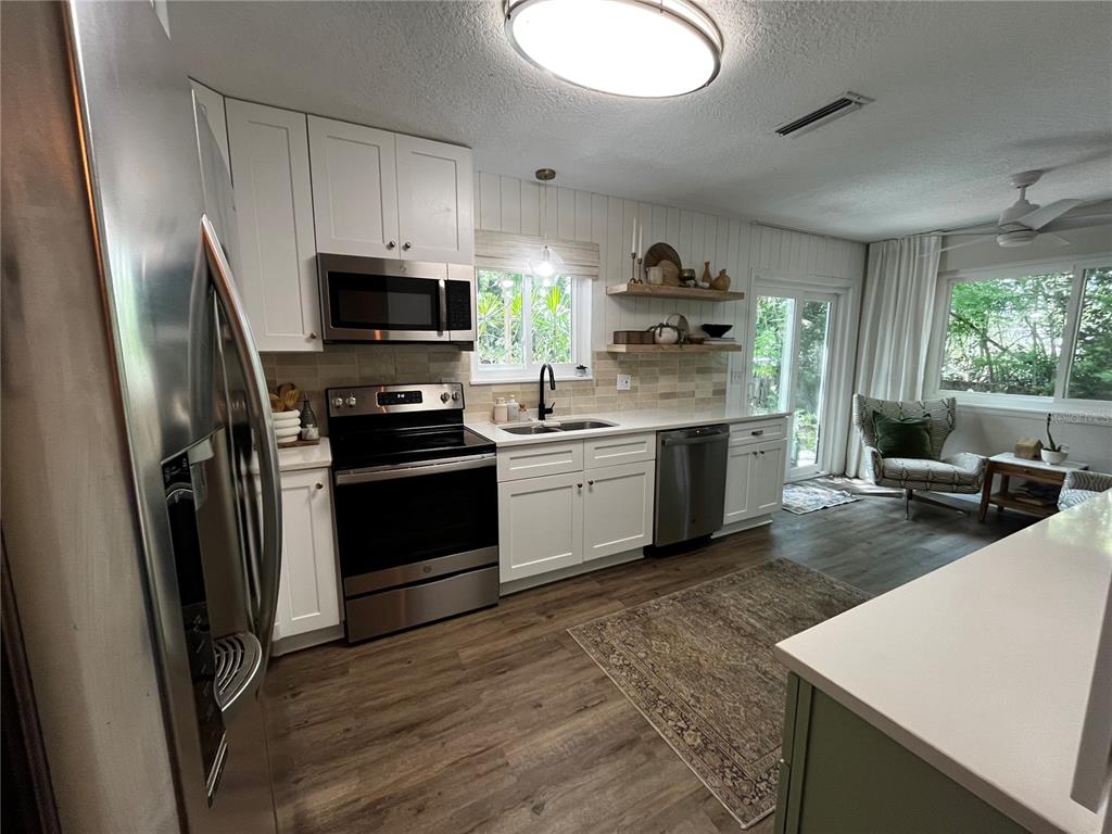 16 Raintree Court Ormond Beach, FL 32174 - Photo 7 of 37 a kitchen with a sink a stove and refrigerator