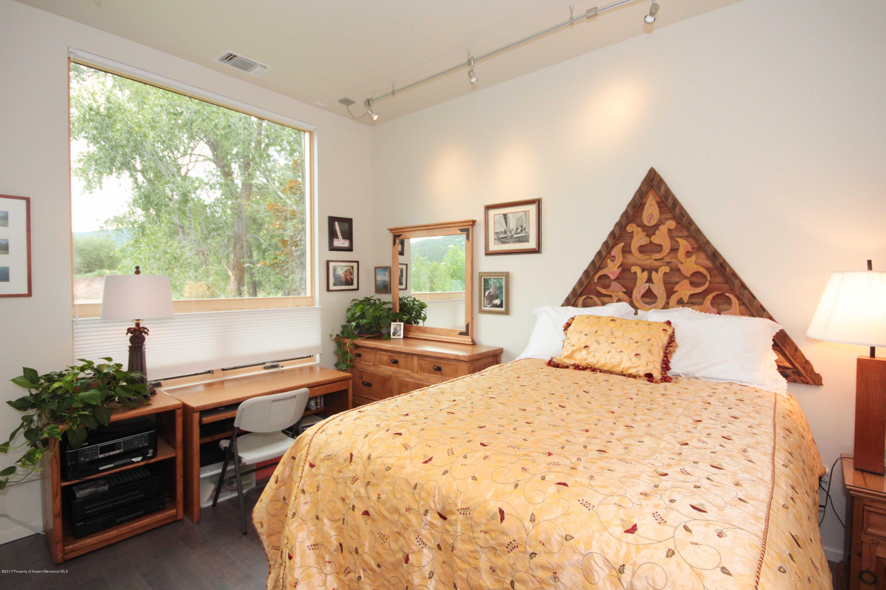 104 Evans Road, Unit 106 Basalt, CO 81621 - Photo 4 of 10 a bedroom with a bed and wooden floor