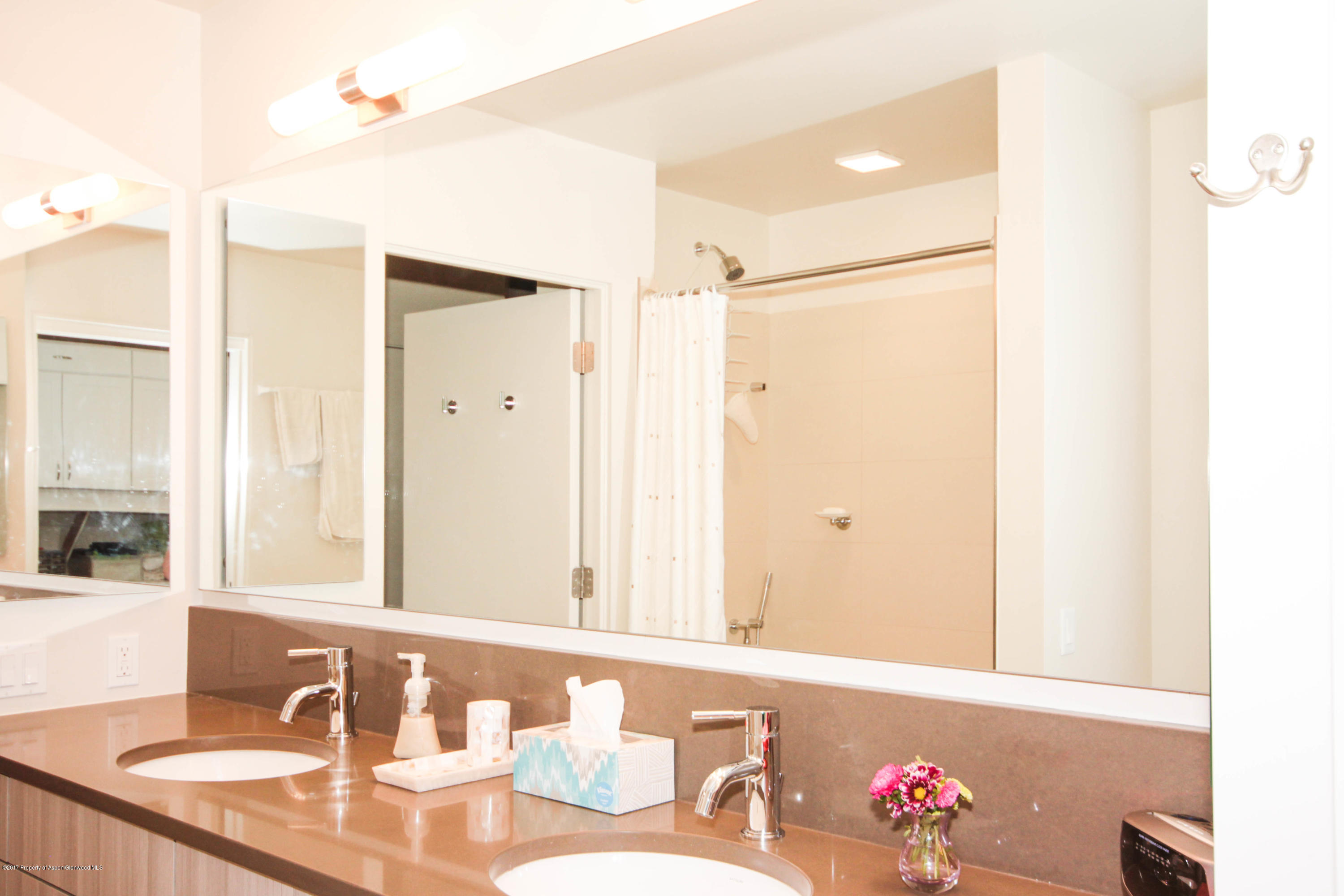104 Evans Road, Unit 106 Basalt, CO 81621 - Photo 5 of 10 a bathroom with a granite countertop sink and a mirror