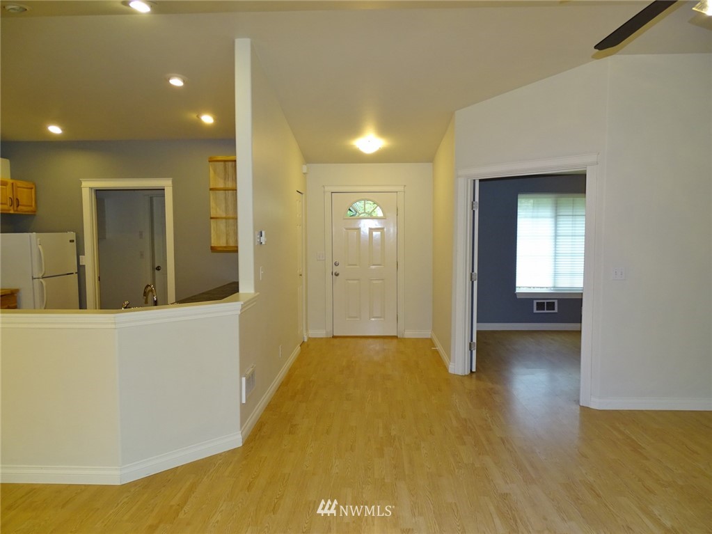 301 Harbor View Loop Southeast Ocean Shores, WA 98569 - Photo 11 of 29 a view of a livingroom with wooden floor and a ceiling fan