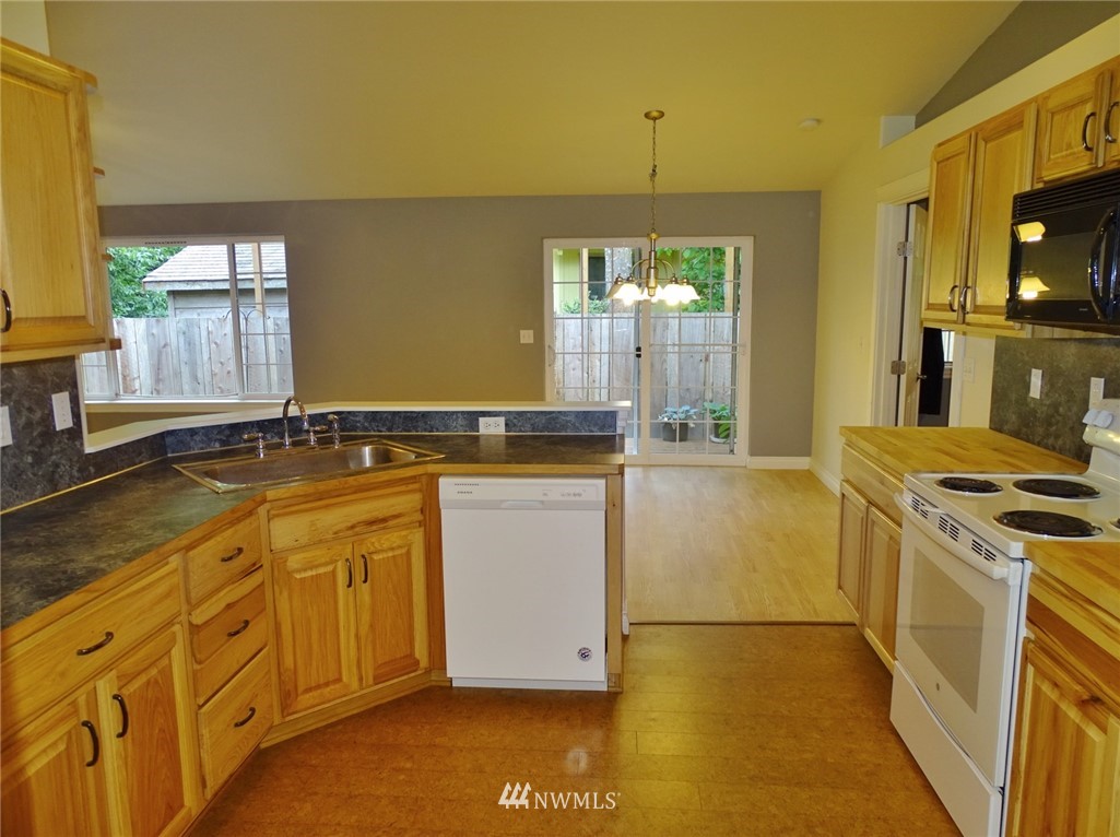 301 Harbor View Loop Southeast Ocean Shores, WA 98569 - Photo 18 of 29 a kitchen with granite countertop a stove and a sink