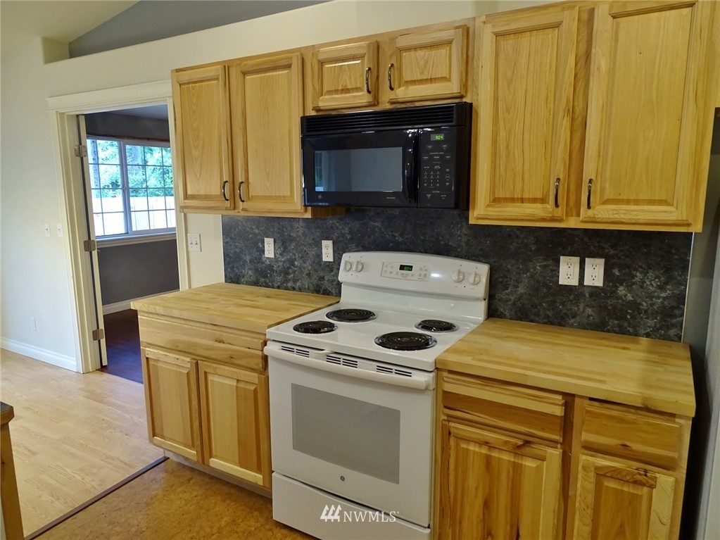 301 Harbor View Loop Southeast Ocean Shores, WA 98569 - Photo 19 of 29 a kitchen with a stove and a microwave