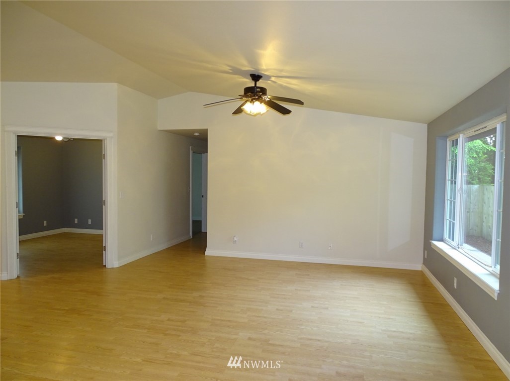 301 Harbor View Loop Southeast Ocean Shores, WA 98569 - Photo 20 of 29 an empty room with windows and fan
