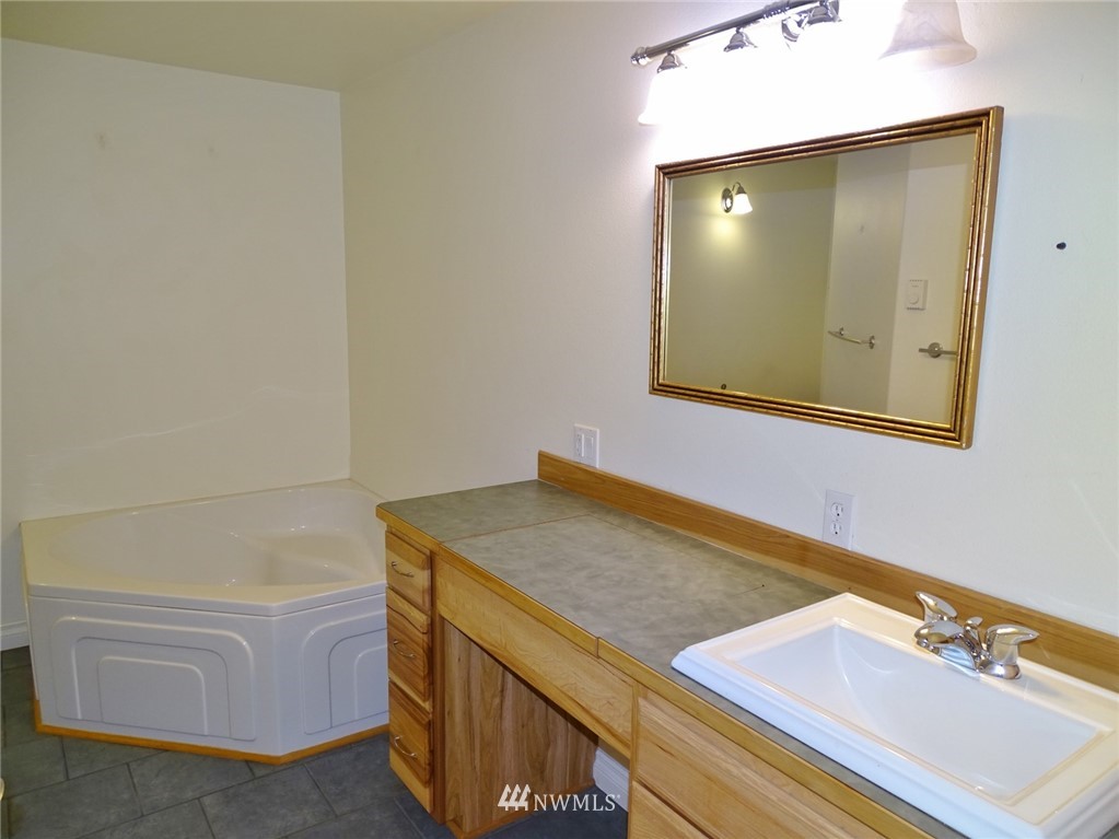 301 Harbor View Loop Southeast Ocean Shores, WA 98569 - Photo 24 of 29 a bathroom with a tub and sink