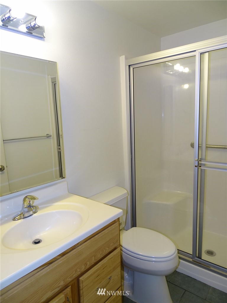 301 Harbor View Loop Southeast Ocean Shores, WA 98569 - Photo 28 of 29 a bathroom with a sink and a mirror