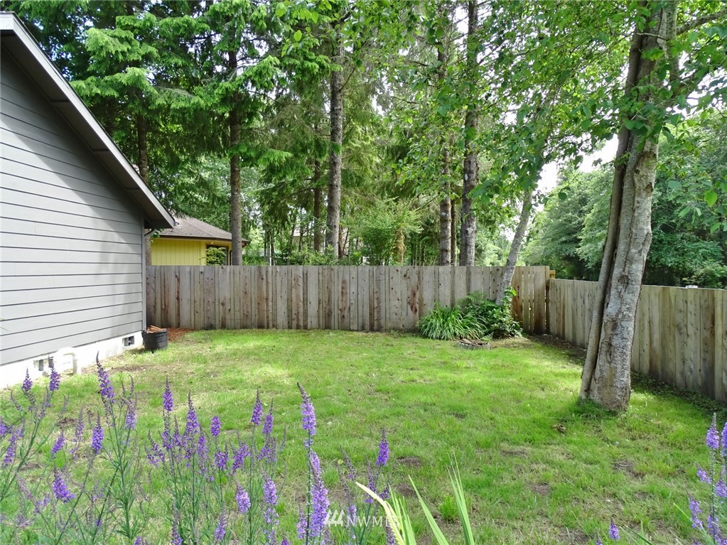 301 Harbor View Loop Southeast Ocean Shores, WA 98569 - Photo 8 of 29 a backyard of a house with lots of green space