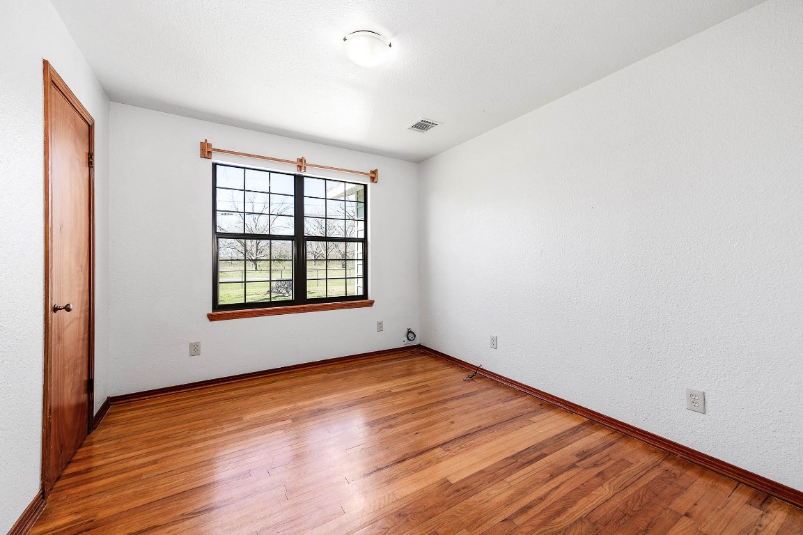 2474 Gates Road Alvin, TX 77511 - Photo 21 of 37 BEDROOM WITH DOUBLE PANE WINDOWS AND HARDWOOD FLOORING