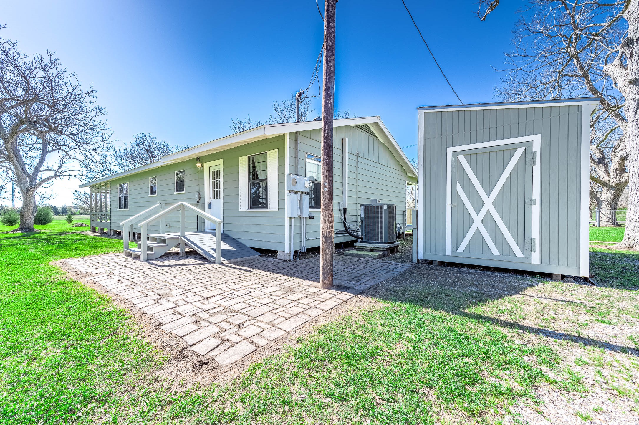 2474 Gates Road Alvin, TX 77511 - Photo 32 of 37 BACK OF HOME WITH PATIO AREA AND A RAMP FOR BETTER ACCESS