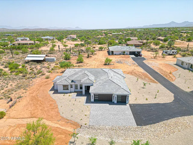 a large kitchen with lots of counter space a sink appliances and a large window