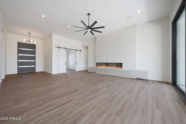 a kitchen with stainless steel appliances a refrigerator and a hard wood floor