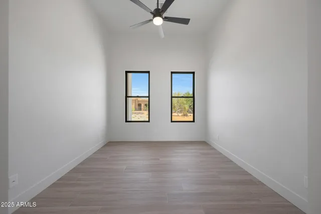 an empty room with windows and entrance