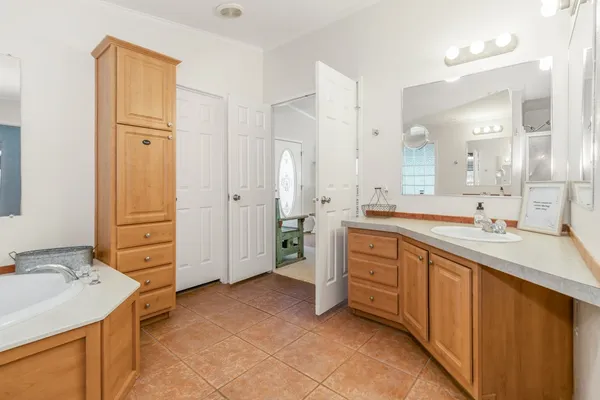 a bathroom with a tub sink and mirror