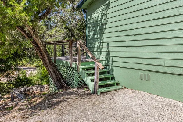 a view of a balcony with wooden floor and bench