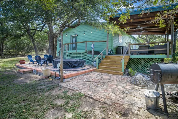 a backyard of a house with fire pit and outdoor seating