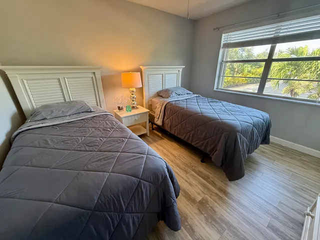 a bedroom with a bed and a large window